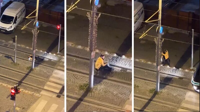 Sürücü tramvay yolunda yatan şəxsi yuxusundan oyatdı - VİDEO