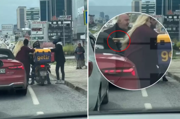 Sürücü tıxacda mübahisə etdiyi kuryerə silah doğrultdu - VİDEO